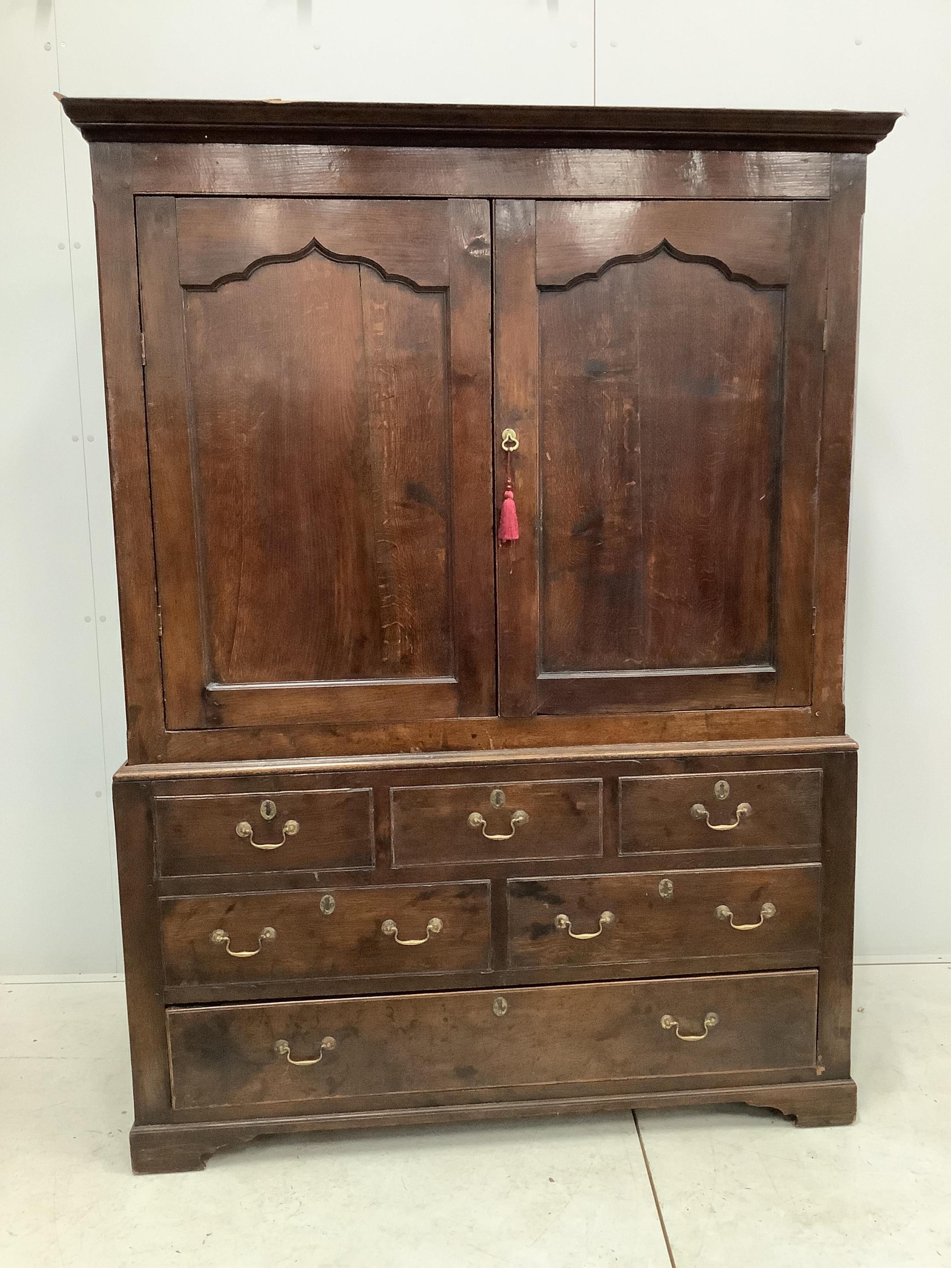 An early 18th century and later oak press cupboard with two doors and one base drawer, width 140cm, height 185cm. Condition - fair to good